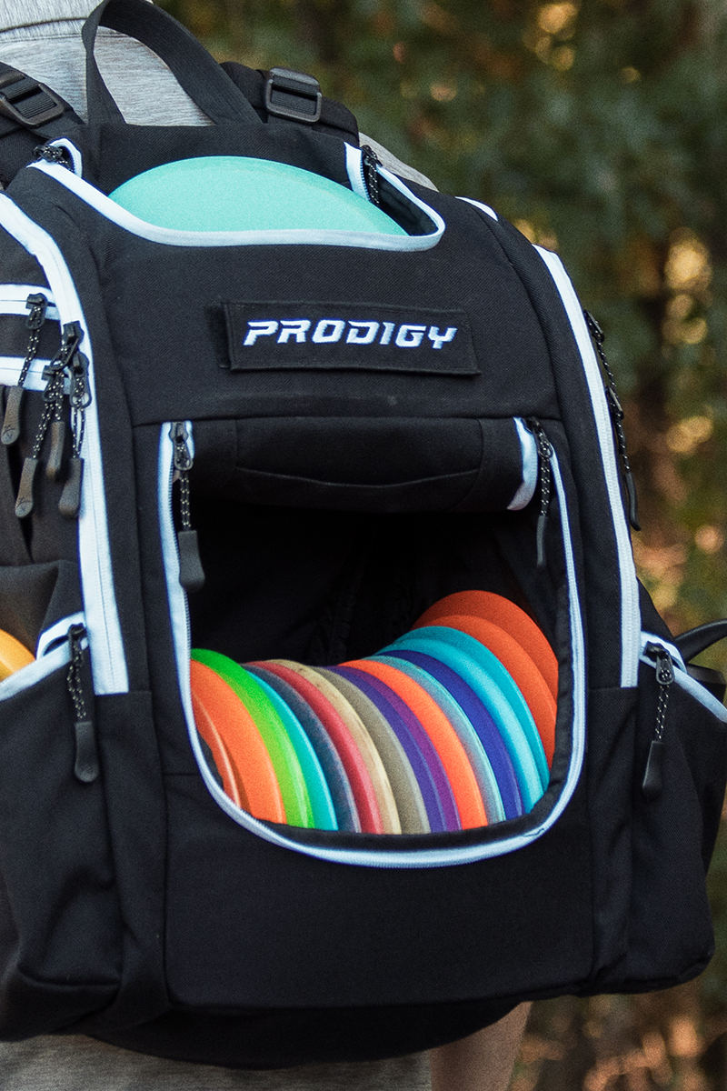 prodigy disc golf apex xl bag on the back of a disc golfer